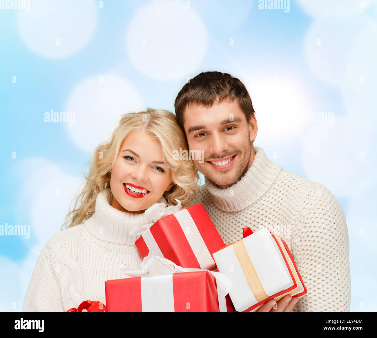 smiling man and woman with presents Stock Photo - Alamy