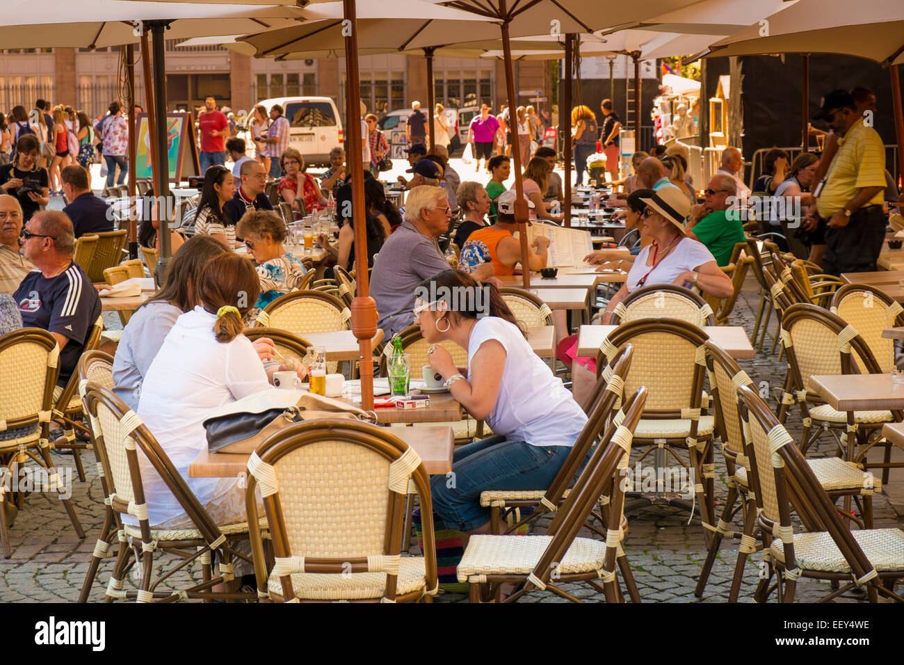 Strasbourg, France, Europe - Tourists eating at sidewalk cafe restaurants outside the Cathedral Stock Photo