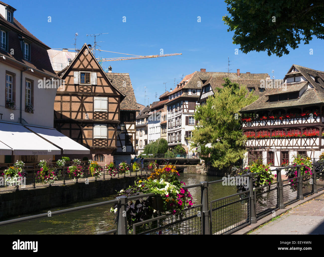 Crane repairing an old historic building in Petite France, Strasbourg, France, Europe with construction crane Stock Photo