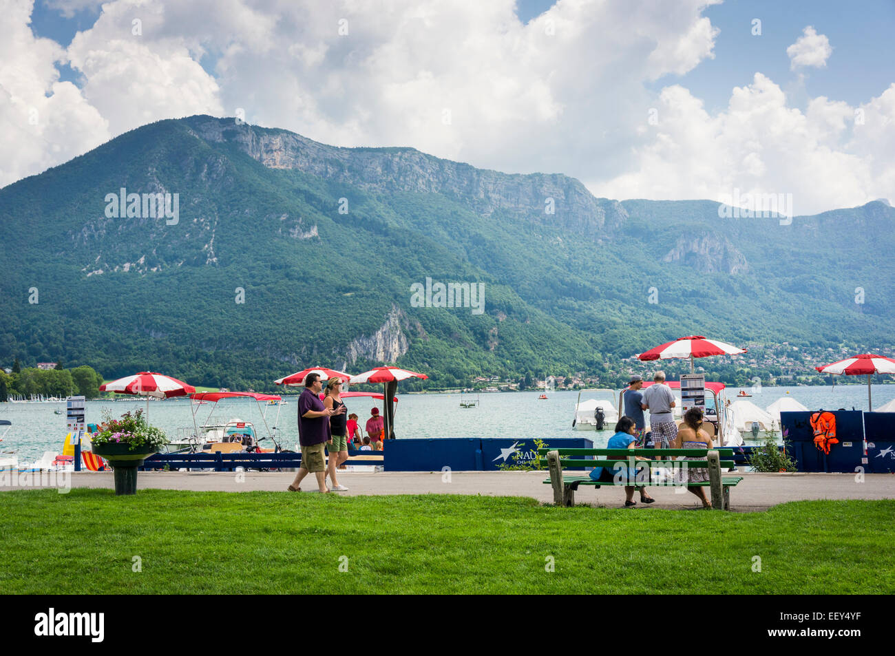 People walking along the shore of Lake Annecy, France, Europe in summer Stock Photo