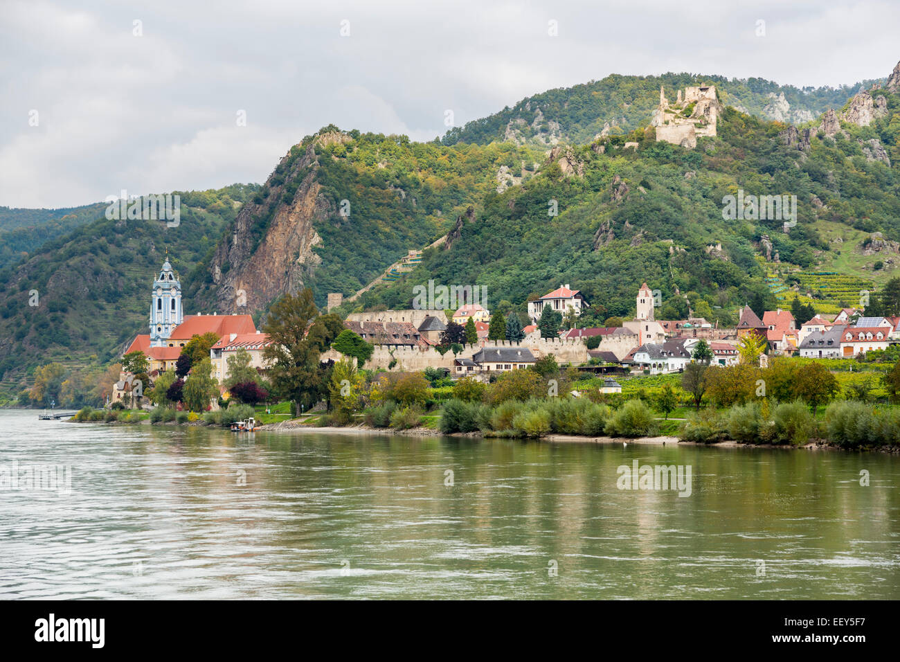 Ornate church, hilltop castle and buildings on banks of River Danube in Durnstein, Austria Stock Photo