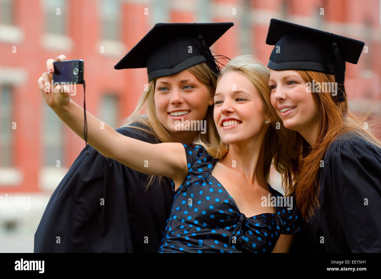Three friends at graduation ceremony Stock Photo