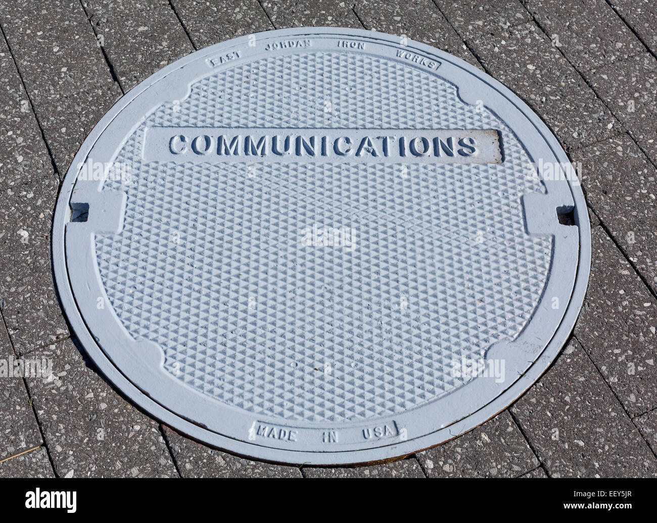 Communications manhole cover in a pavement - communication concept Stock Photo