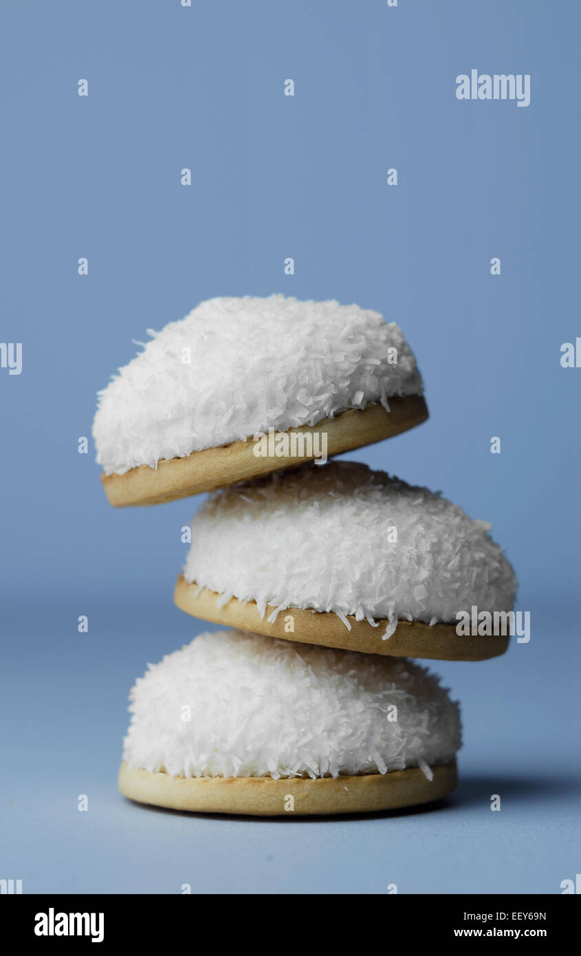 Marshmallow biscuits with coconut sprinkles over blue background Stock Photo Alamy