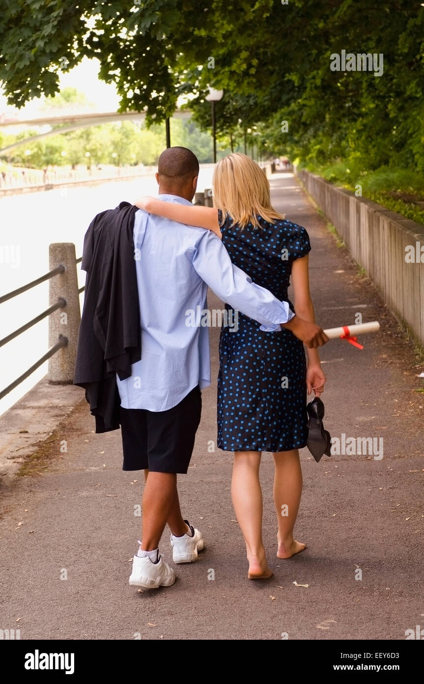 Young man and woman at graduation ceremony Stock Photo