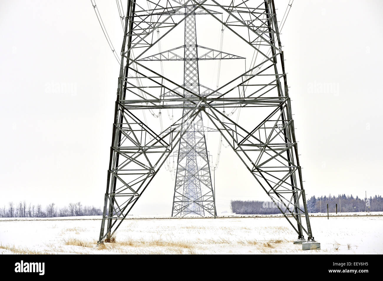 A horizontal image of hydro transmission line towers crossing a road in
