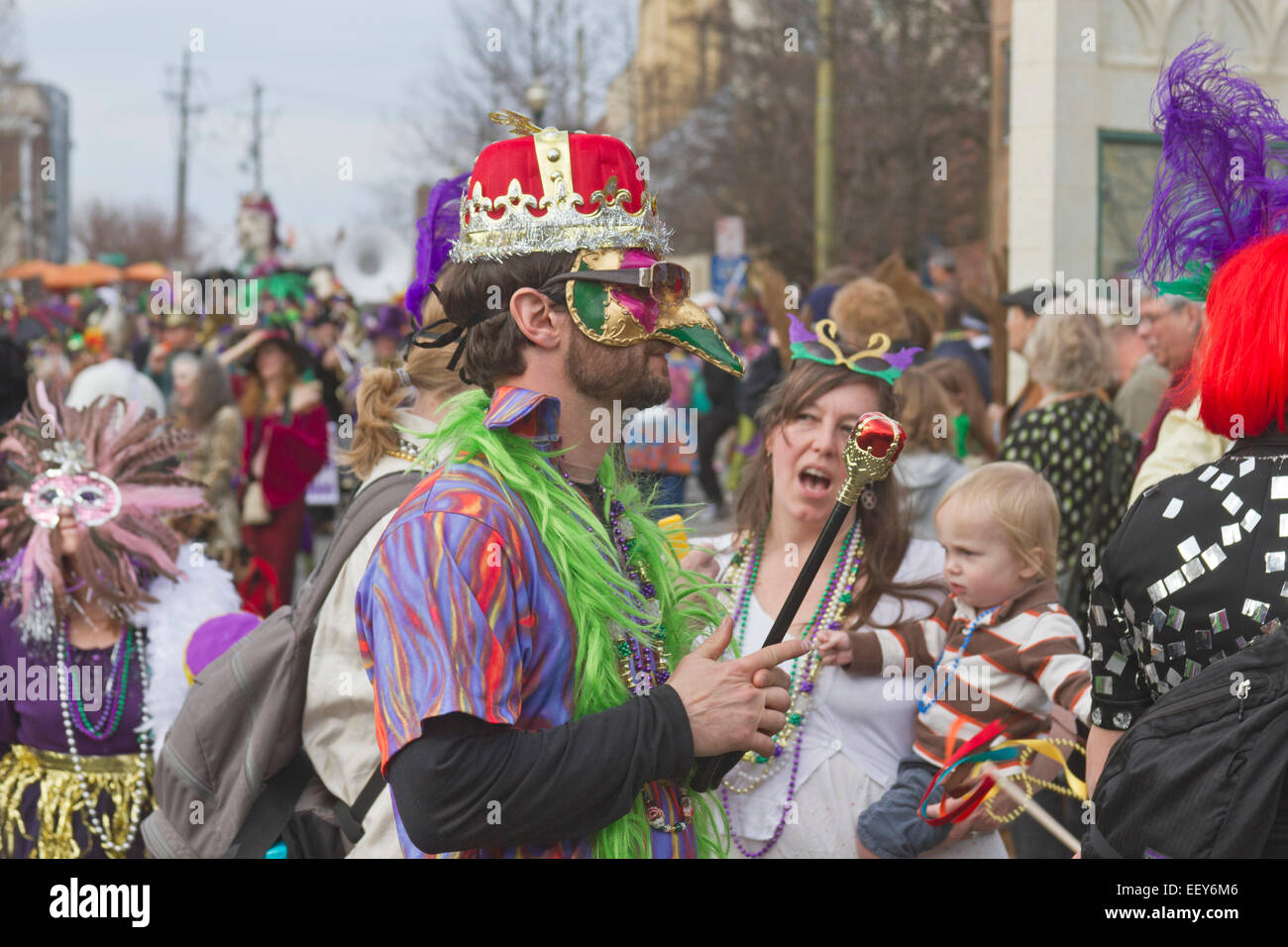 People wear costumes and colorful masks in the annual Mardi Gras parade