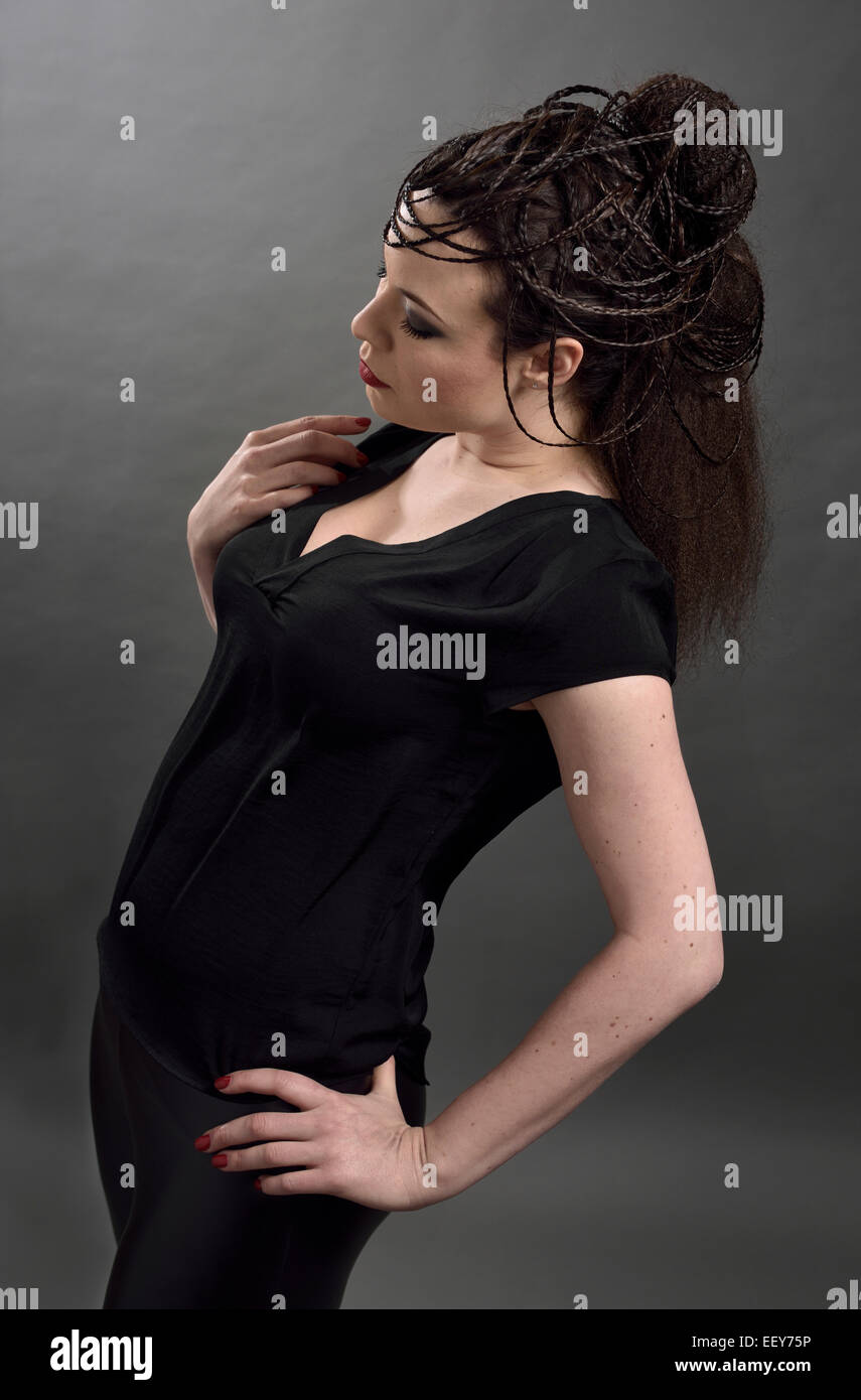 Young female model leaning back with a braided hairstyle Stock Photo