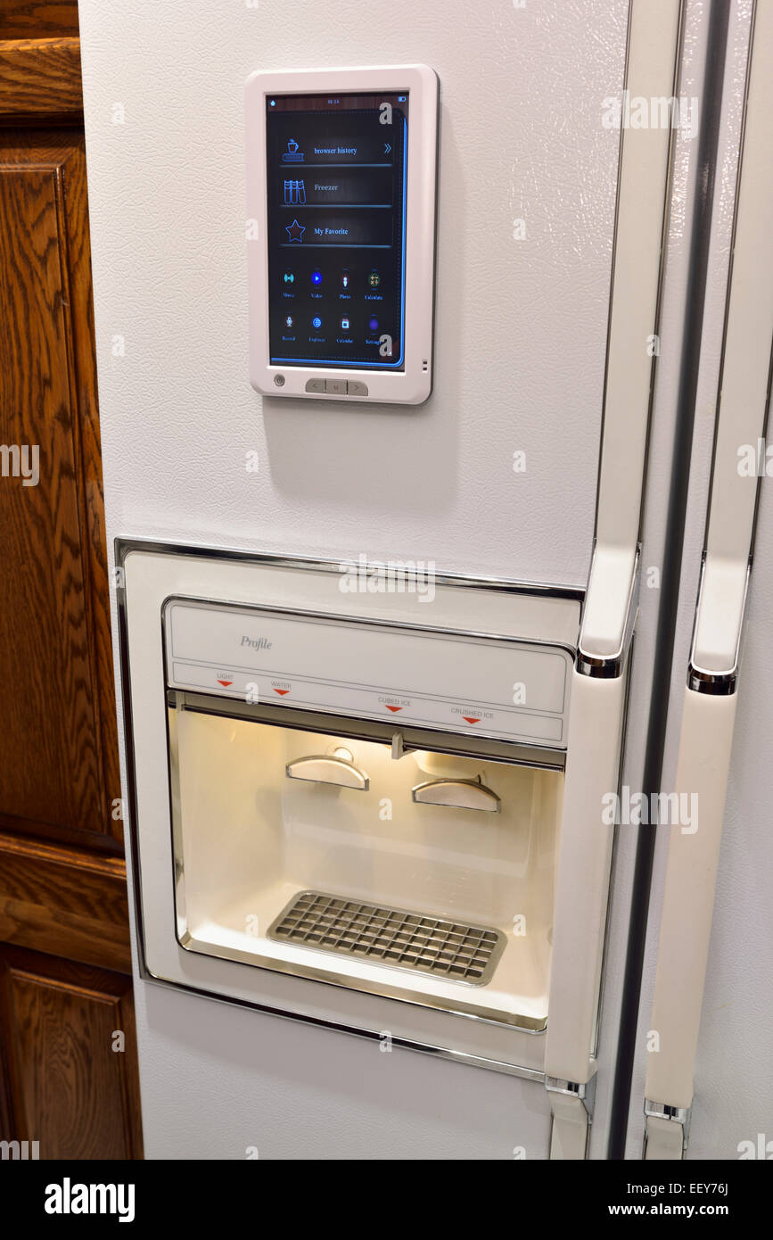 Smart refrigerator with internet of things connectivity touchpad and ice maker and water purifier in modern kitchen Stock Photo