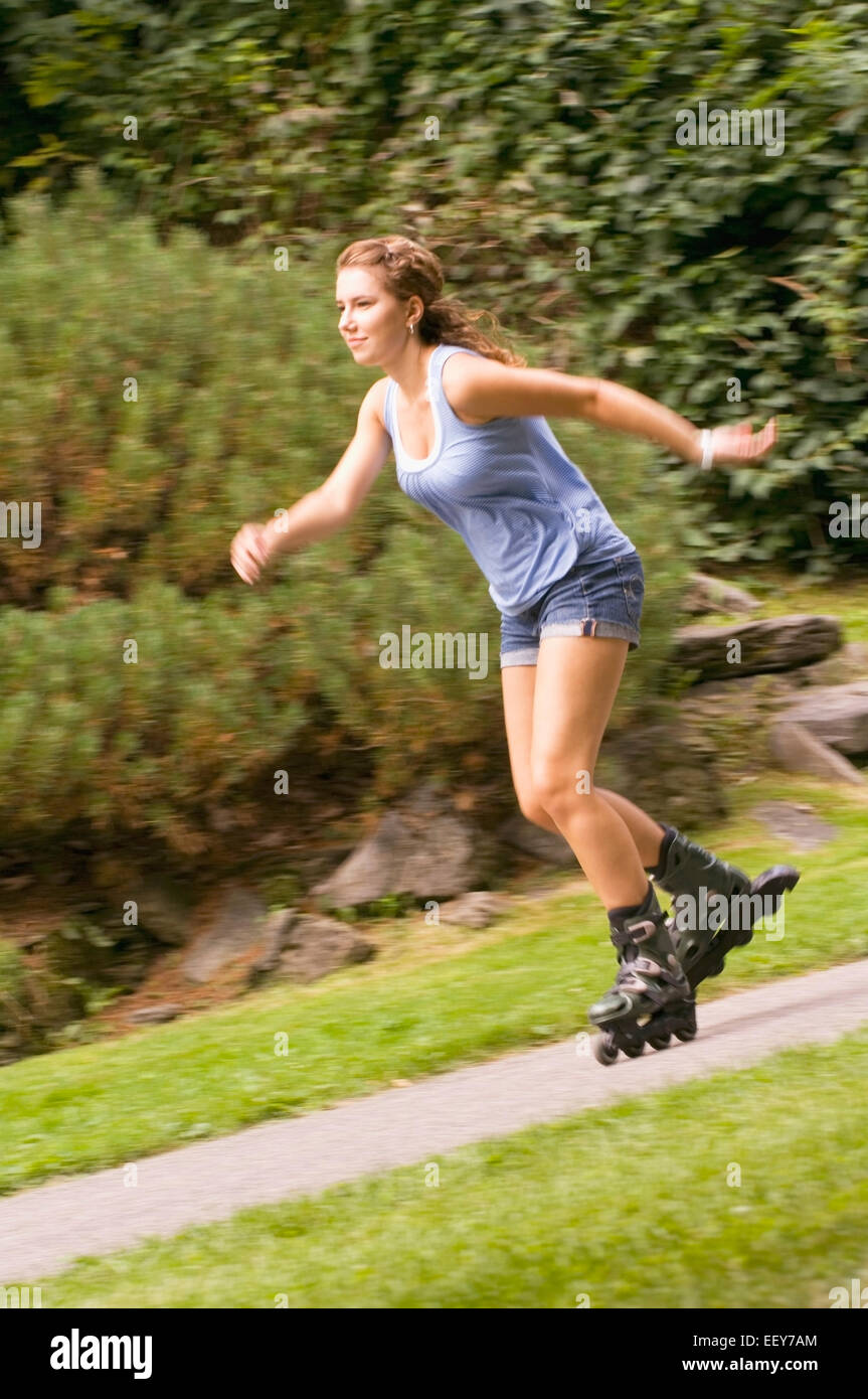 Woman inline skating at a park Stock Photo Alamy