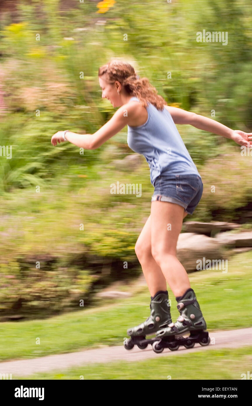 Woman inline skating at a park Stock Photo Alamy