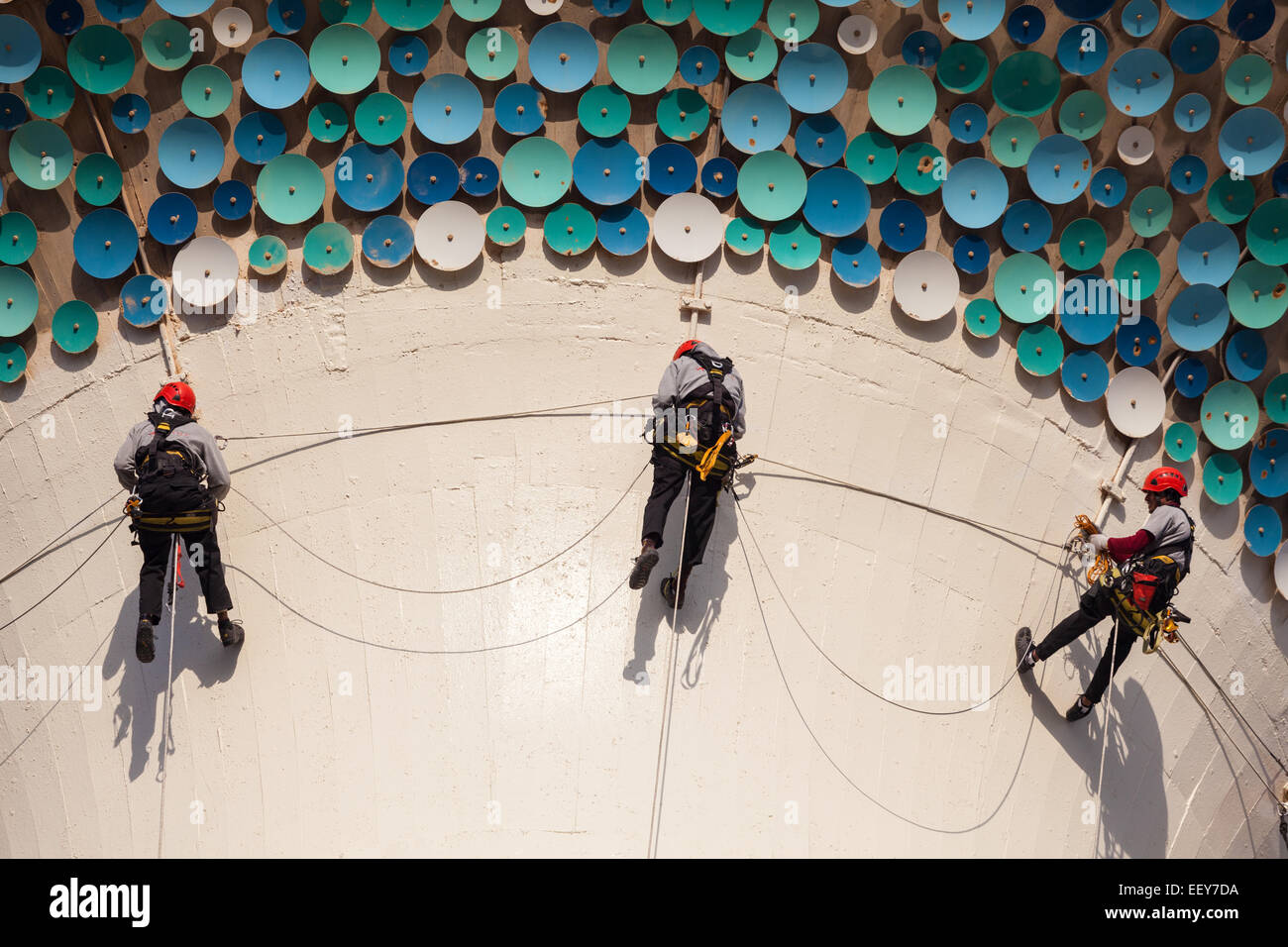 Workers hanging on ropes at the sphere of a Kuwait Tower. Stock Photo