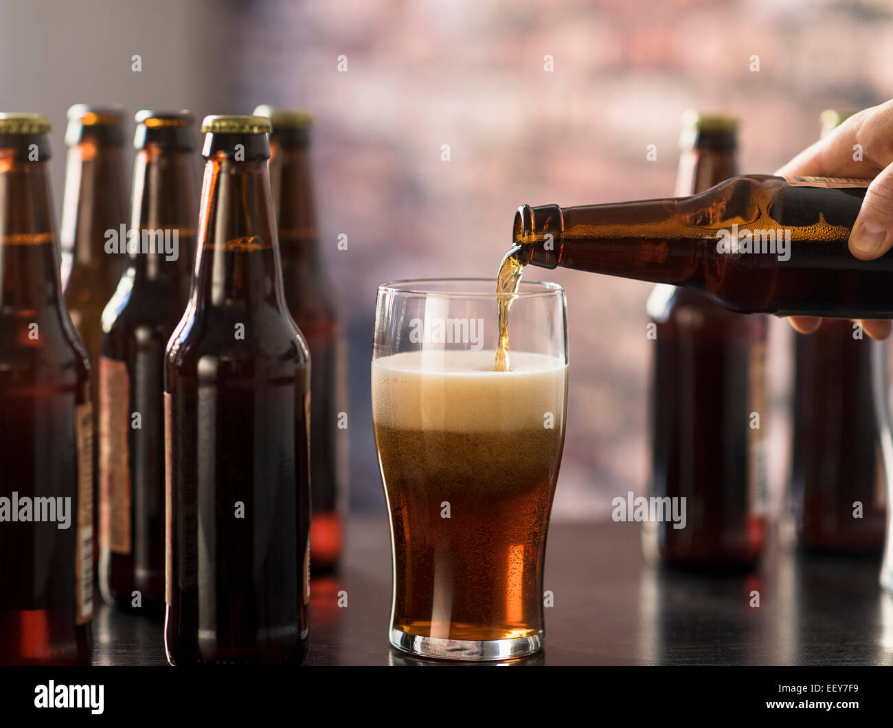 Hand pouring beer Stock Photo