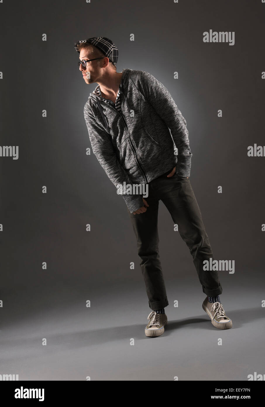 Studio shot of man in gray clothing Stock Photo