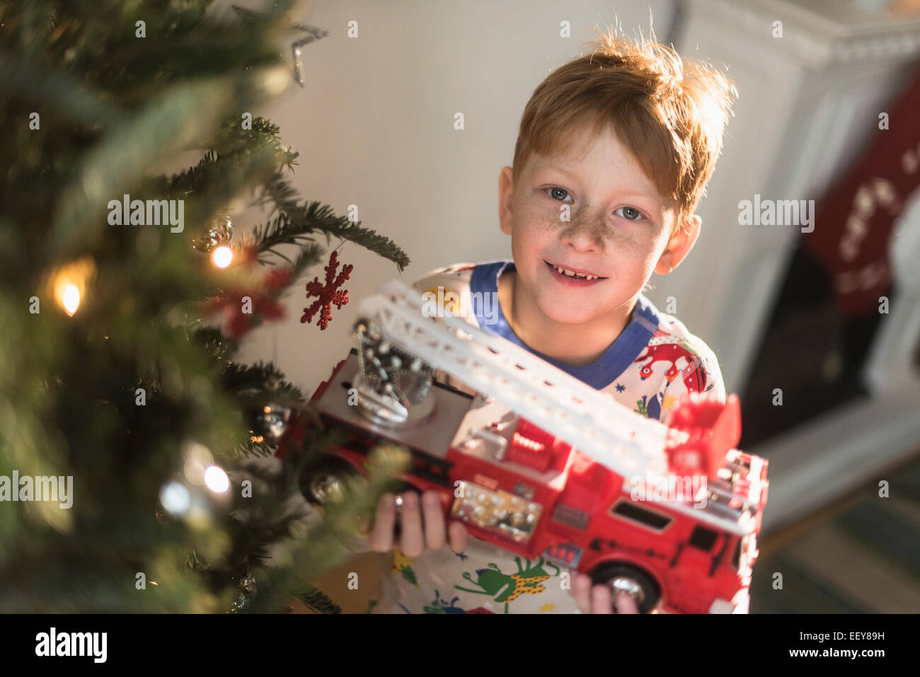 Portrait of boy (6-7) holding toy firetruck Stock Photo
