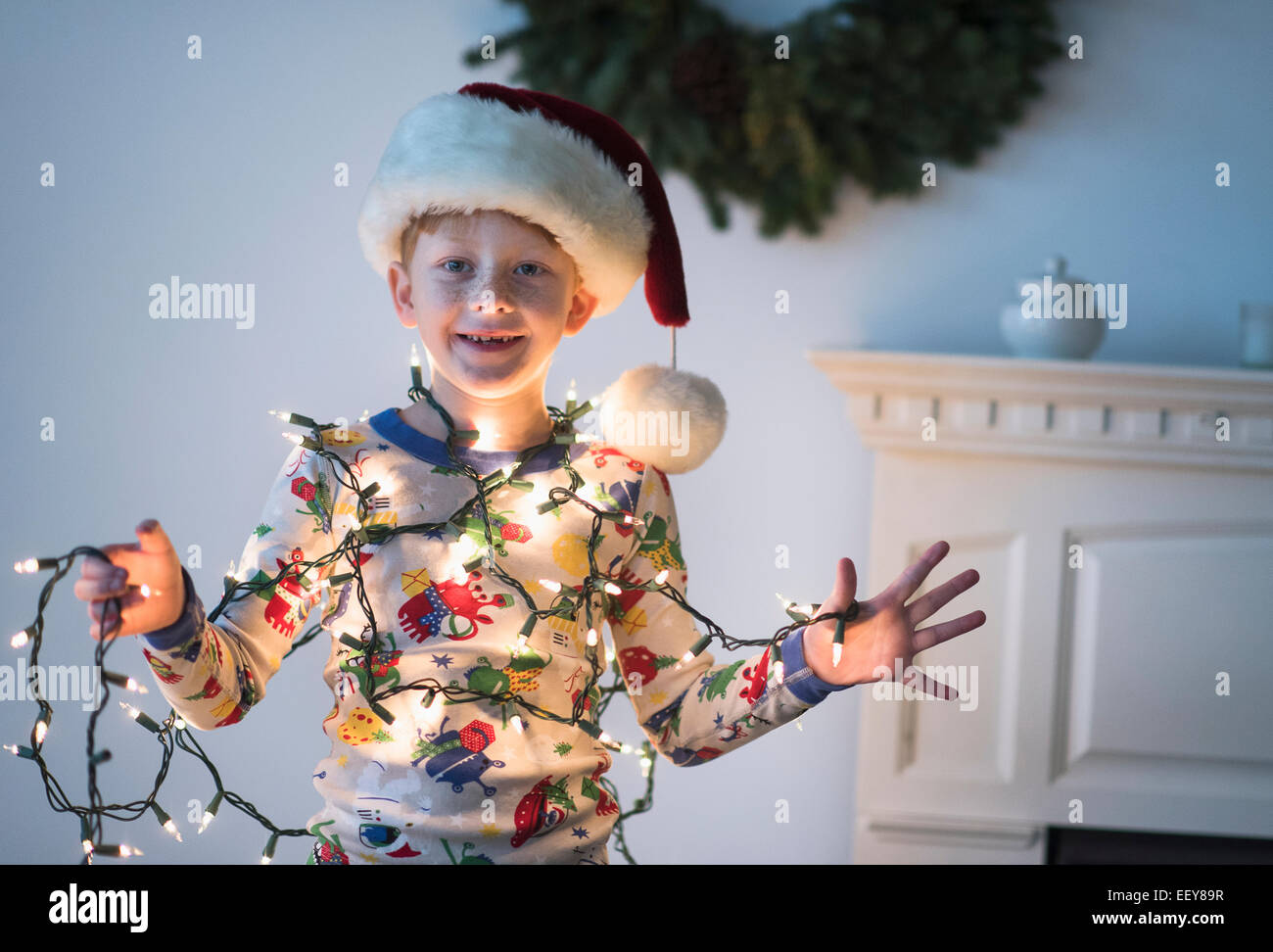 Portrait of boy (6-7) holding christmas lights Stock Photo