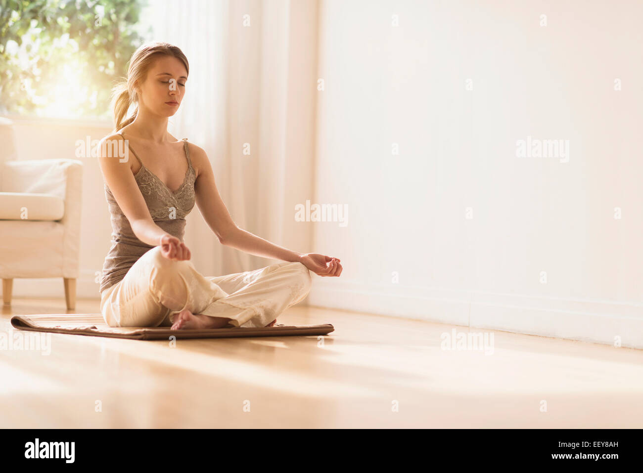 Young woman practicing yoga Stock Photo