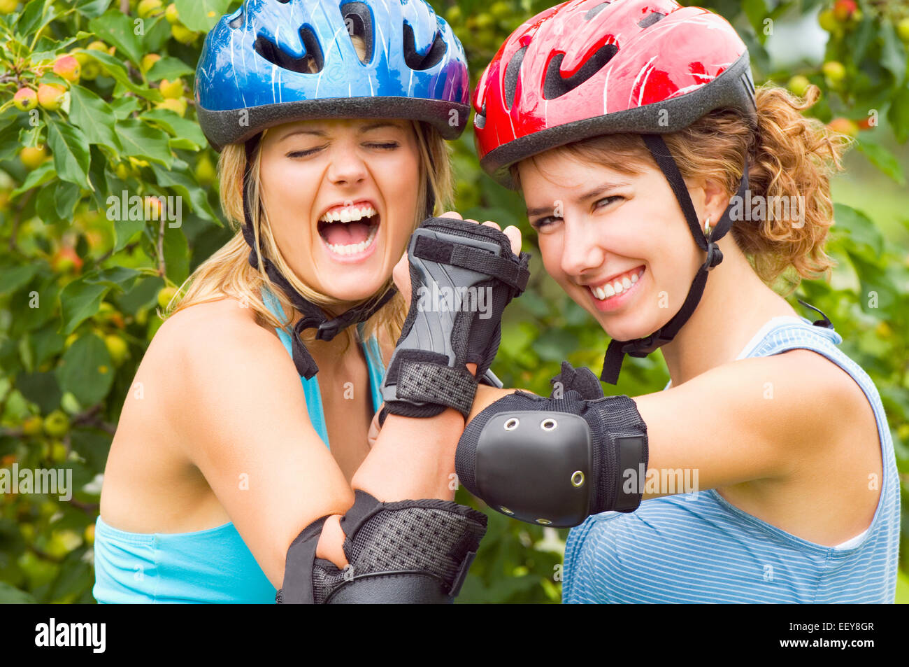 Two women at a park wearing inline skates Stock Photo Alamy