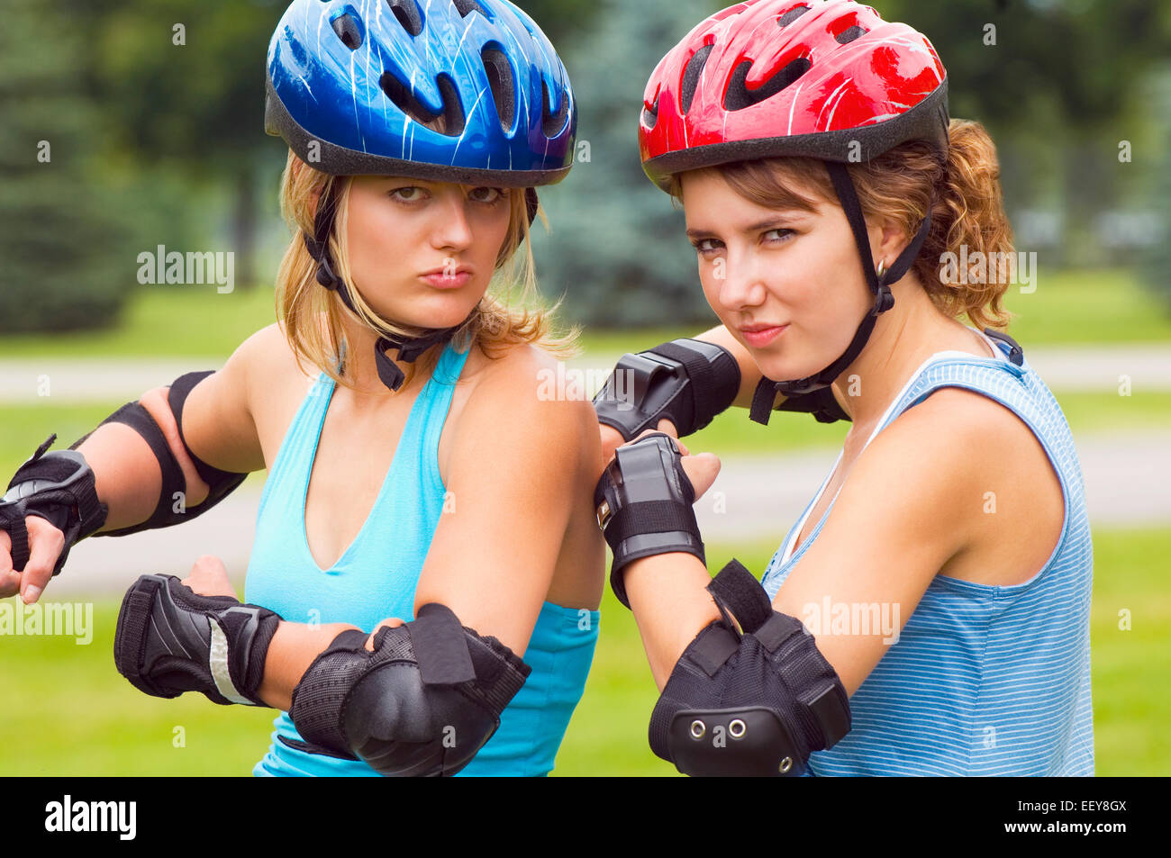 Two women at a park wearing inline skates Stock Photo Alamy