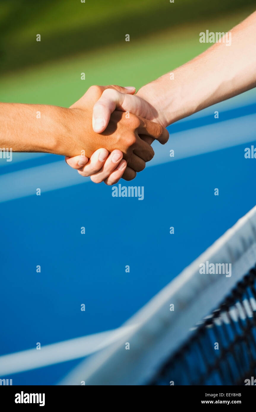 Tennis players shaking hands Stock Photo