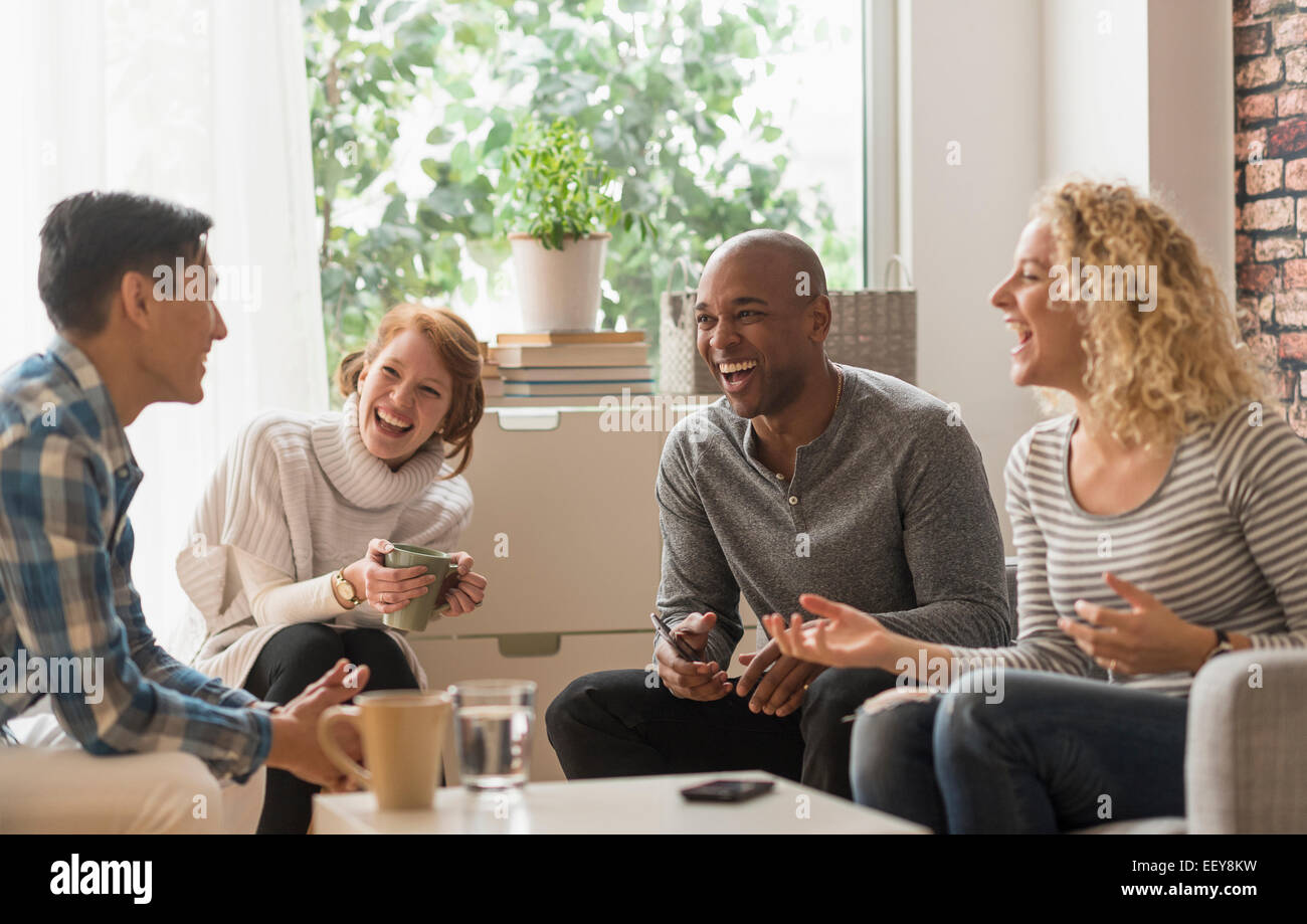 Friends hanging out in living room Stock Photo