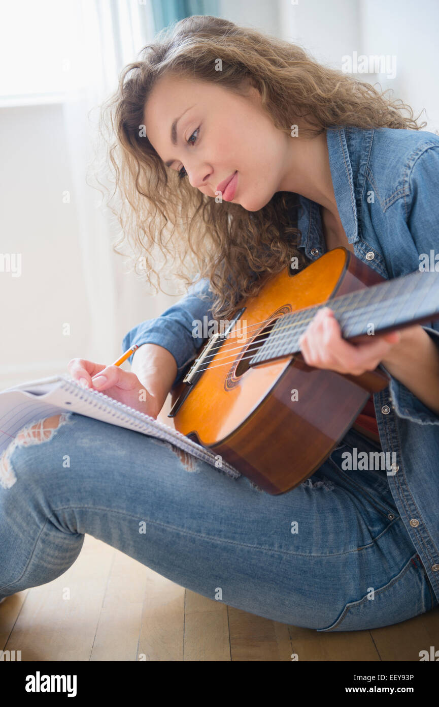 Young woman playing guitar Stock Photo - Alamy