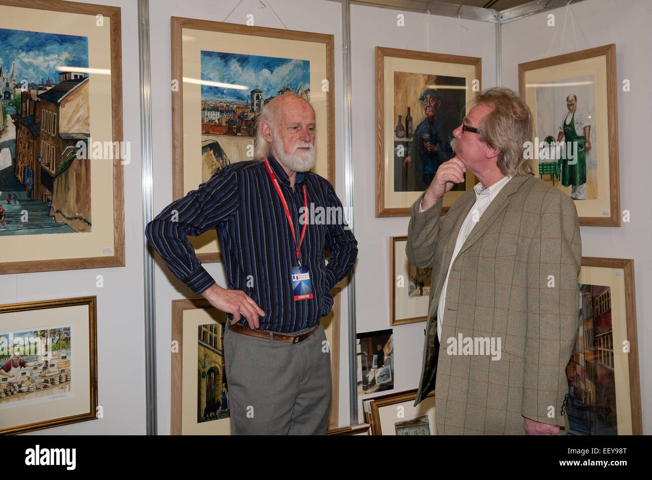 Visitors discuss the artwork for sale at the France Show 2015 in Olympia London Stock Photo
