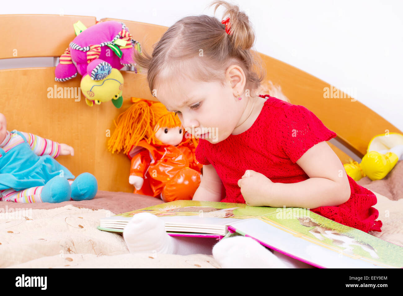 Little girl reading a book Stock Photo