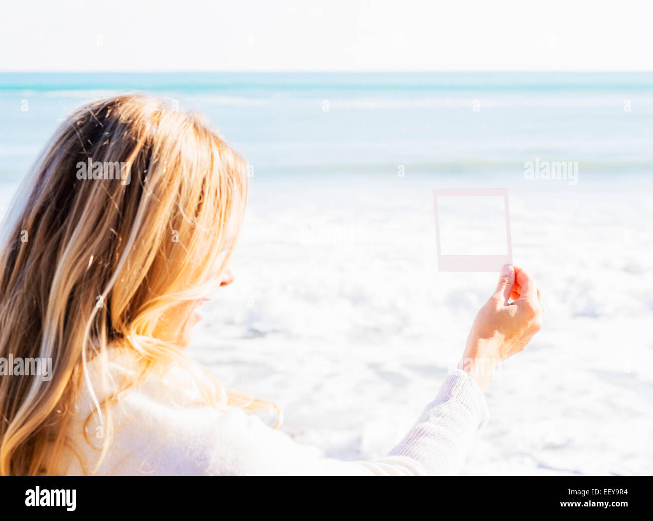 USA, Florida, Jupiter, Woman holding small picture frame Stock Photo