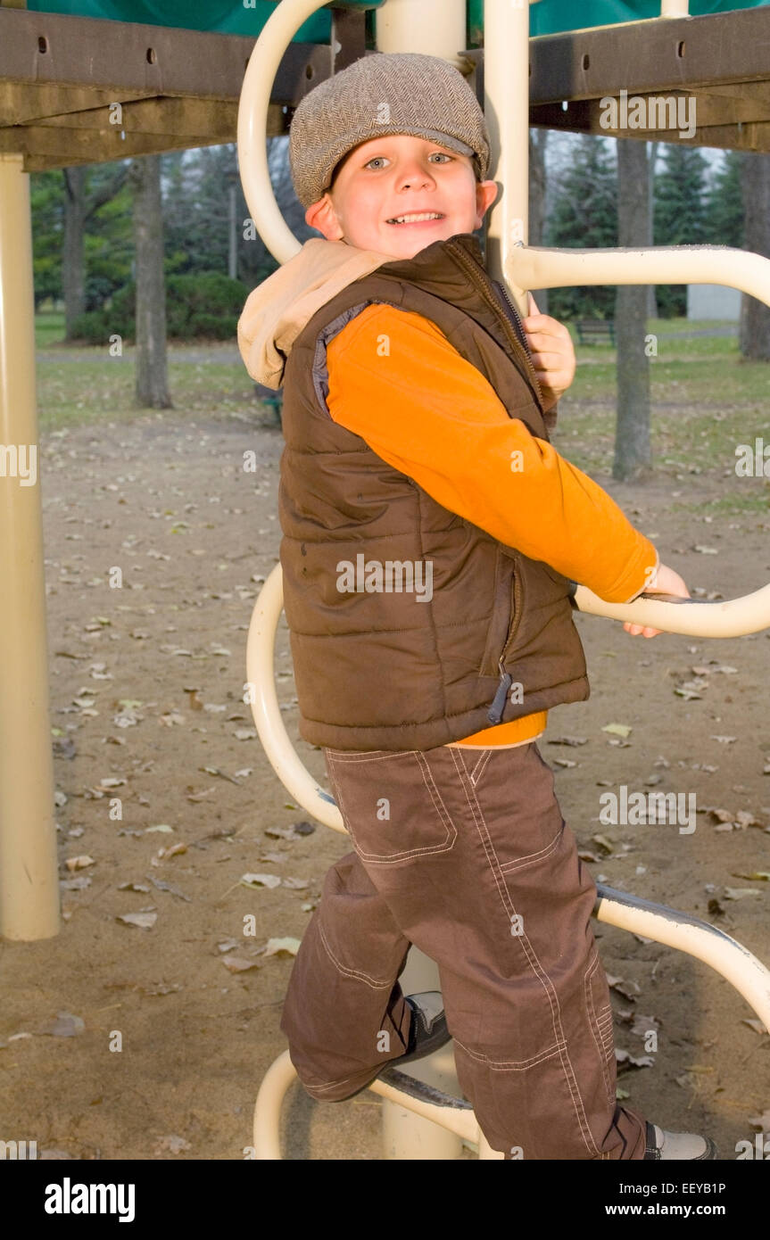 Young boy playing at a playground Stock Photo - Alamy