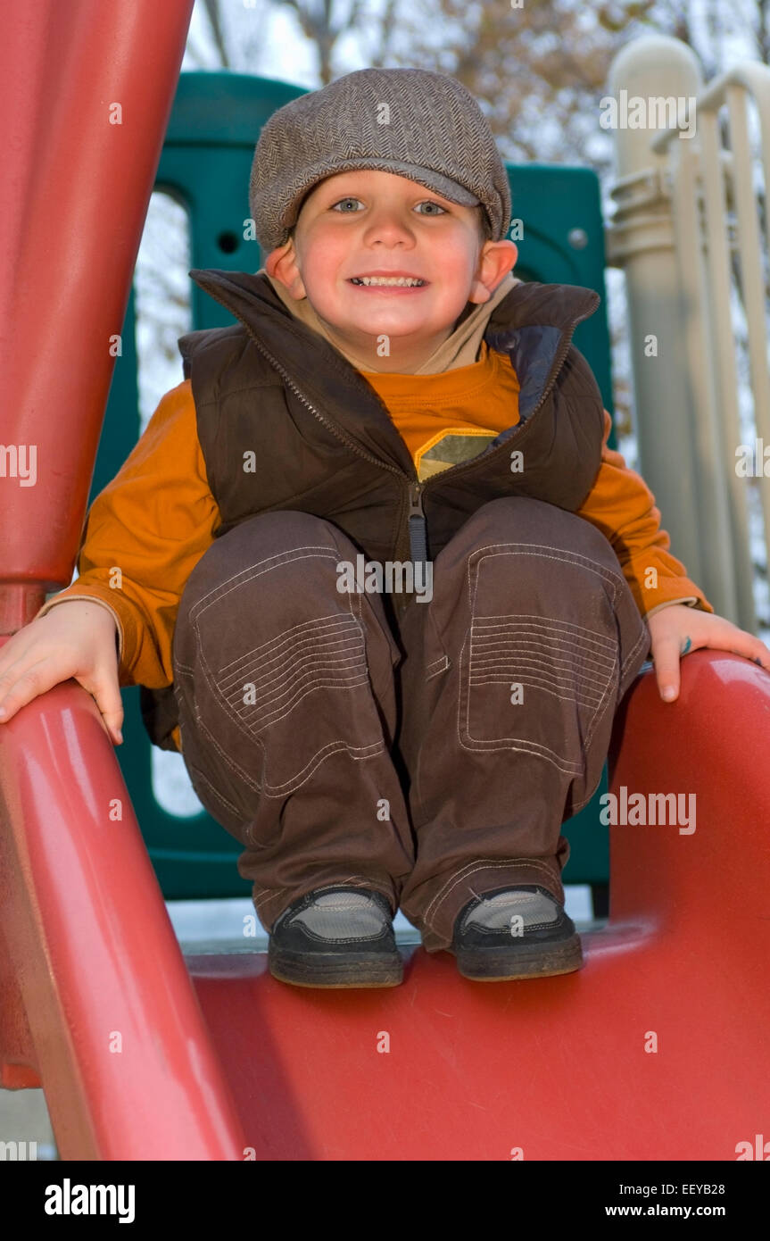 Young boy playing at a playground Stock Photo - Alamy