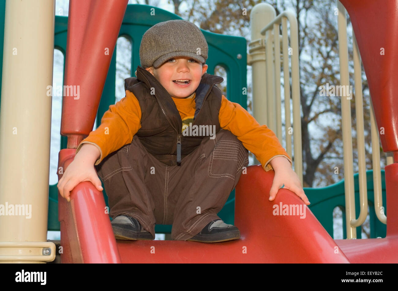 Young boy playing at a playground Stock Photo - Alamy