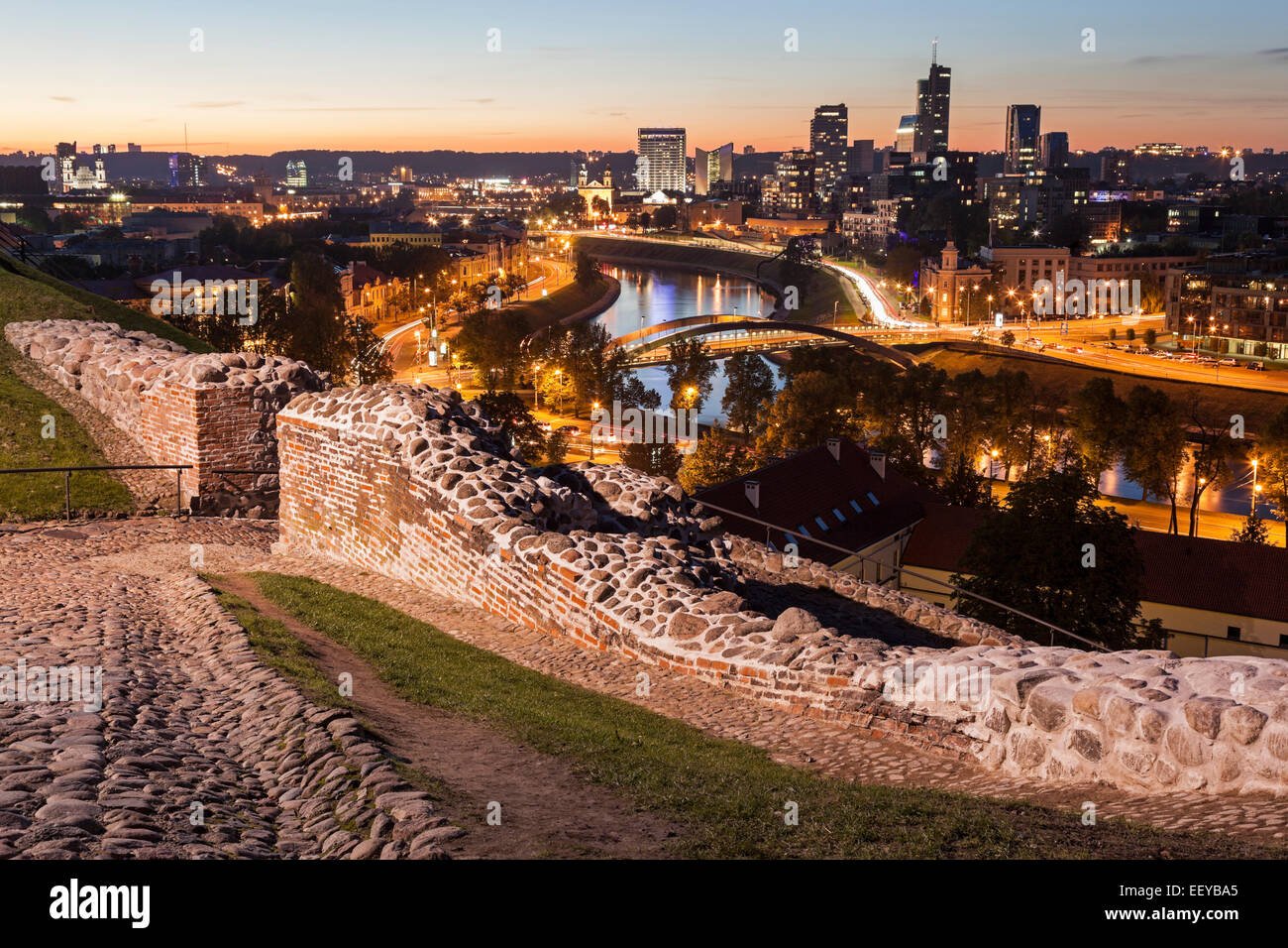 Lithuania, Vilnius, Illuminated riverfront cityscape seen from elevation on opposite bank Stock Photo