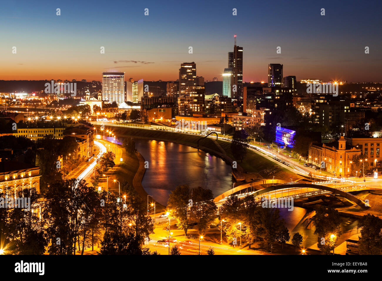 Lithuania, Vilnius, Illuminated riverfront cityscape seen from elevation on opposite bank Stock Photo