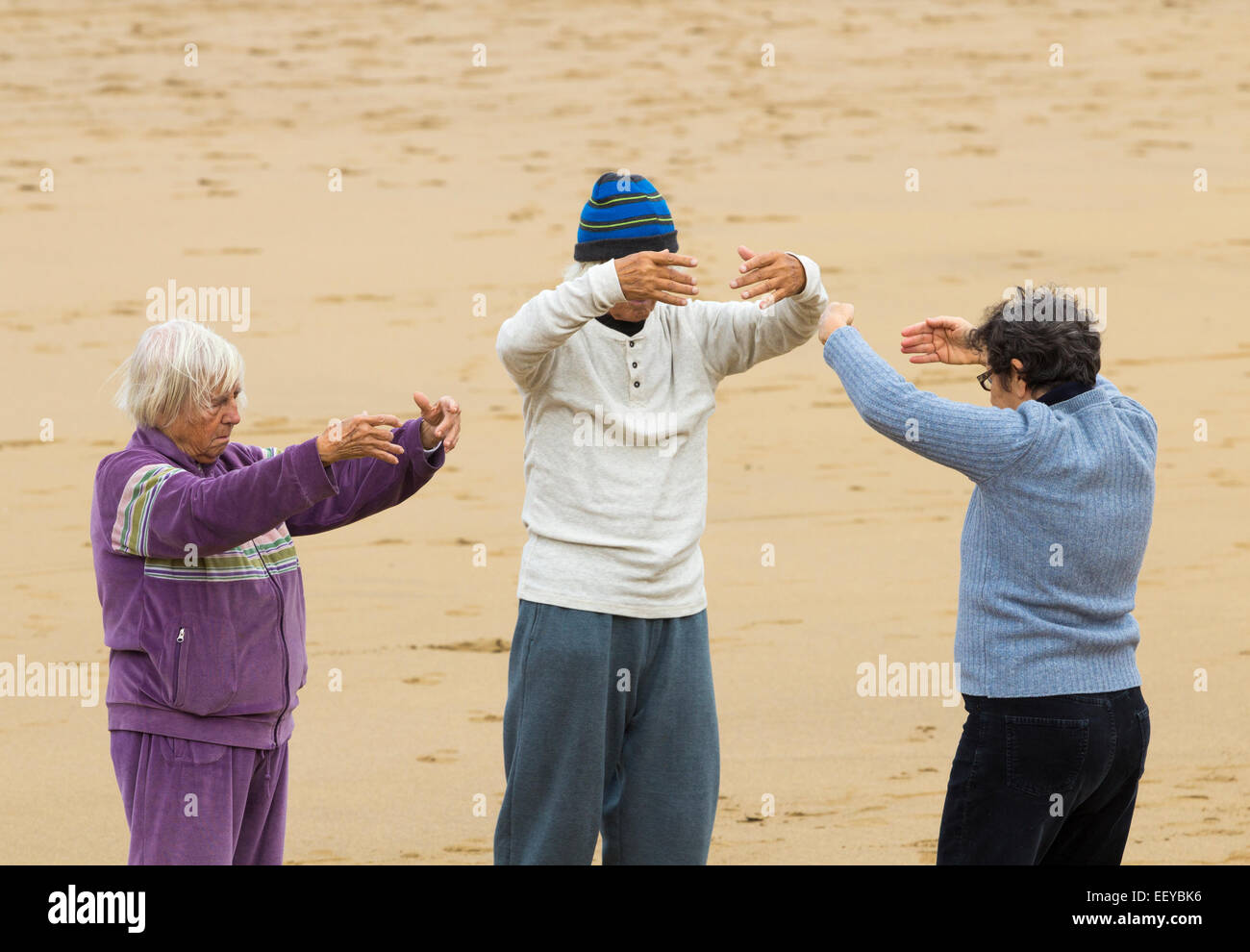 Three elderly people appear to be hugging Invisible trees as they ...