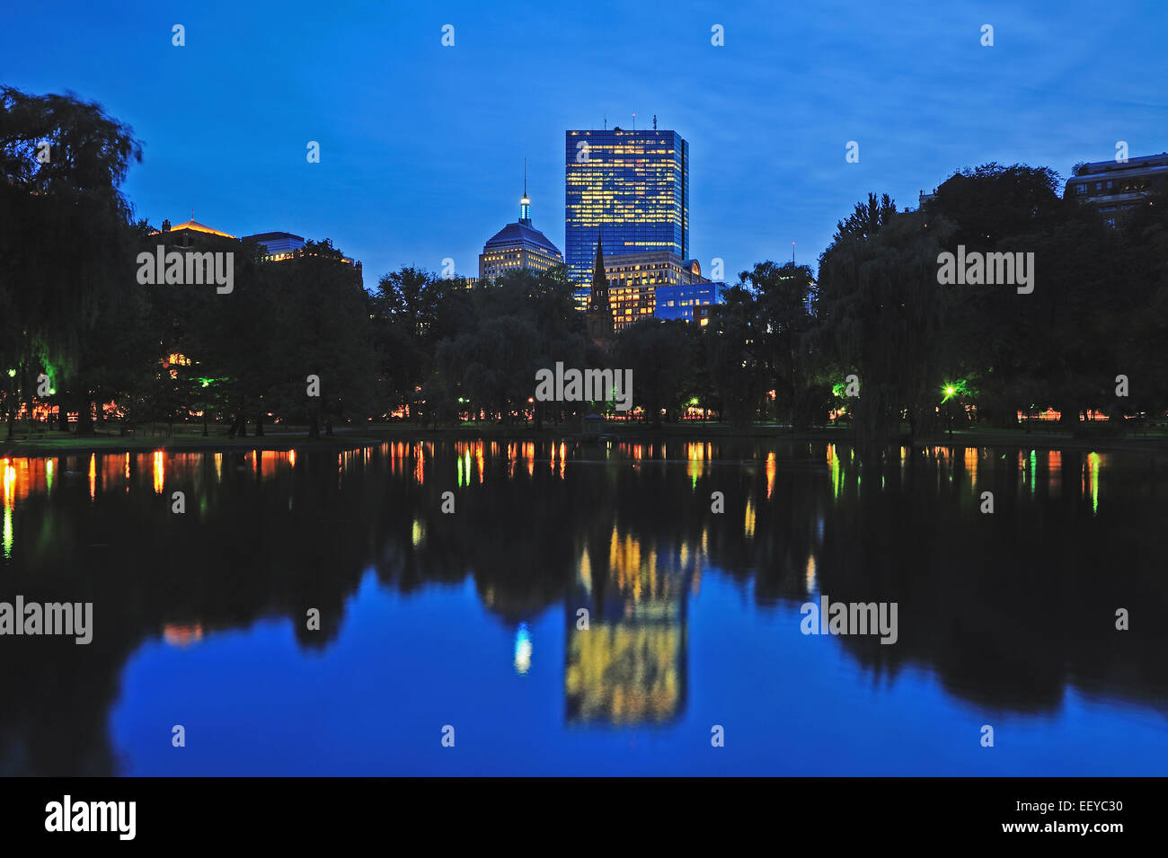 USA, Massachusetts, Boston, Skyline of Copley Square Boston reflecting in pond of Public Gardens at dusk Stock Photo