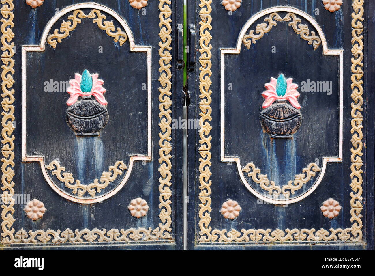 Colorist relief decoration on a dark painted metallic door of a house in Godawari town. Lalitpur distr.-Bagmati zone-Nepal. Stock Photo