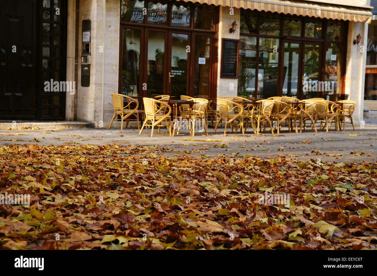 Autumn leaves in front of café Stock Photo