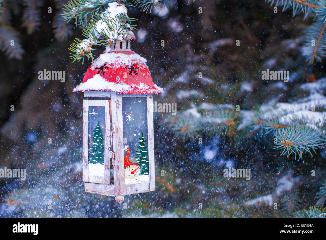 Christmas lantern with snowfall hanging on a fir branch Stock Photo - Alamy