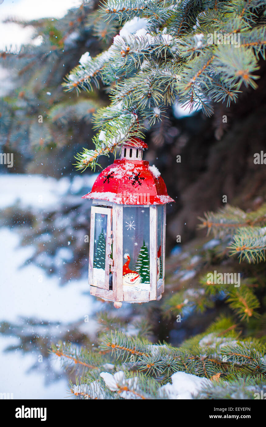 Christmas lantern with snowfall hanging on a fir branch Stock Photo - Alamy