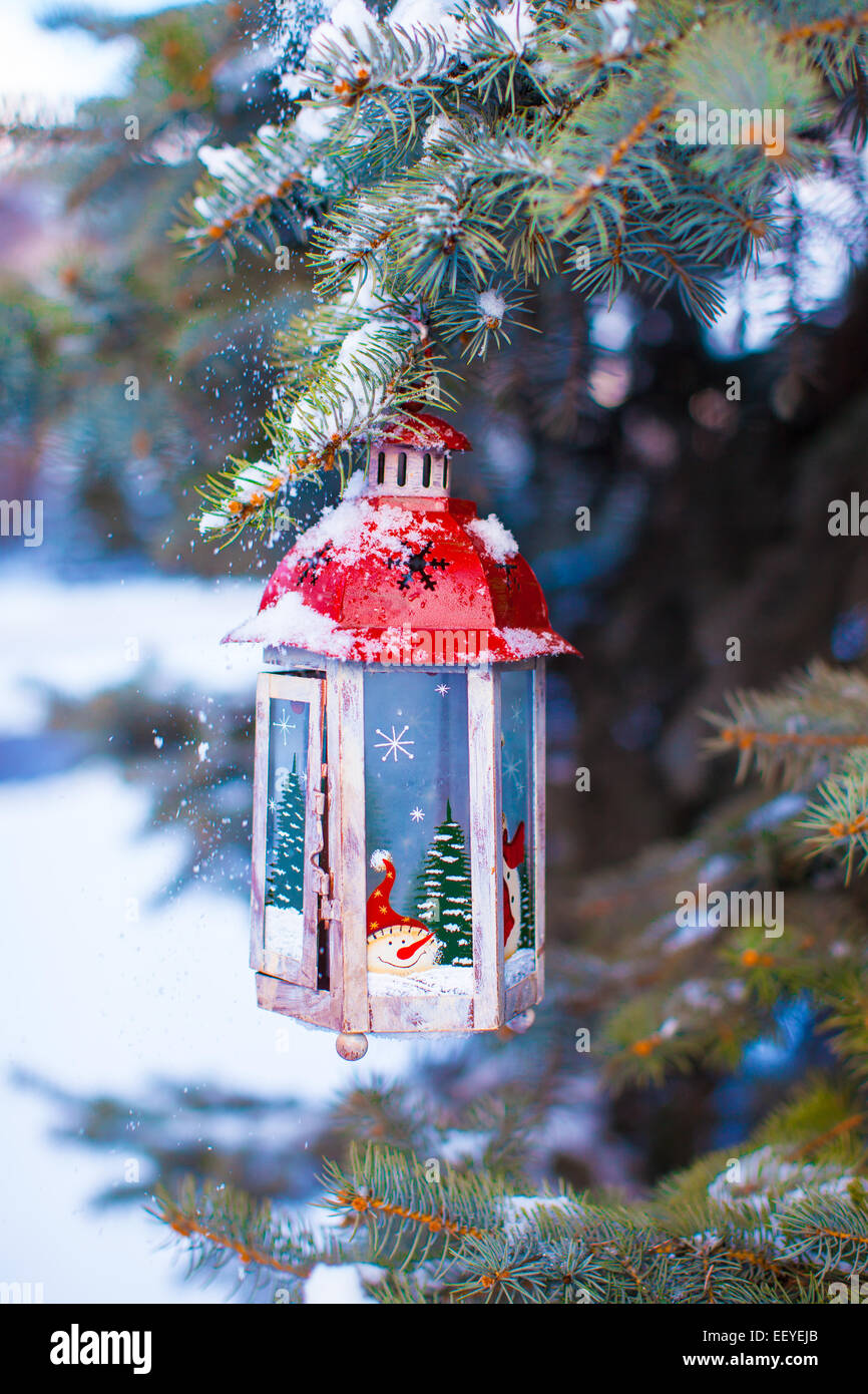 Christmas lantern with snowfall hanging on a fir branch Stock Photo - Alamy
