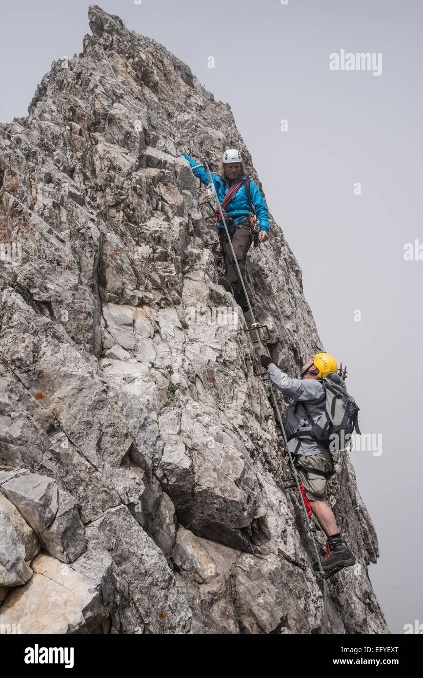 Climbers in action on Klettersteig protected climbing paths Stock Photo