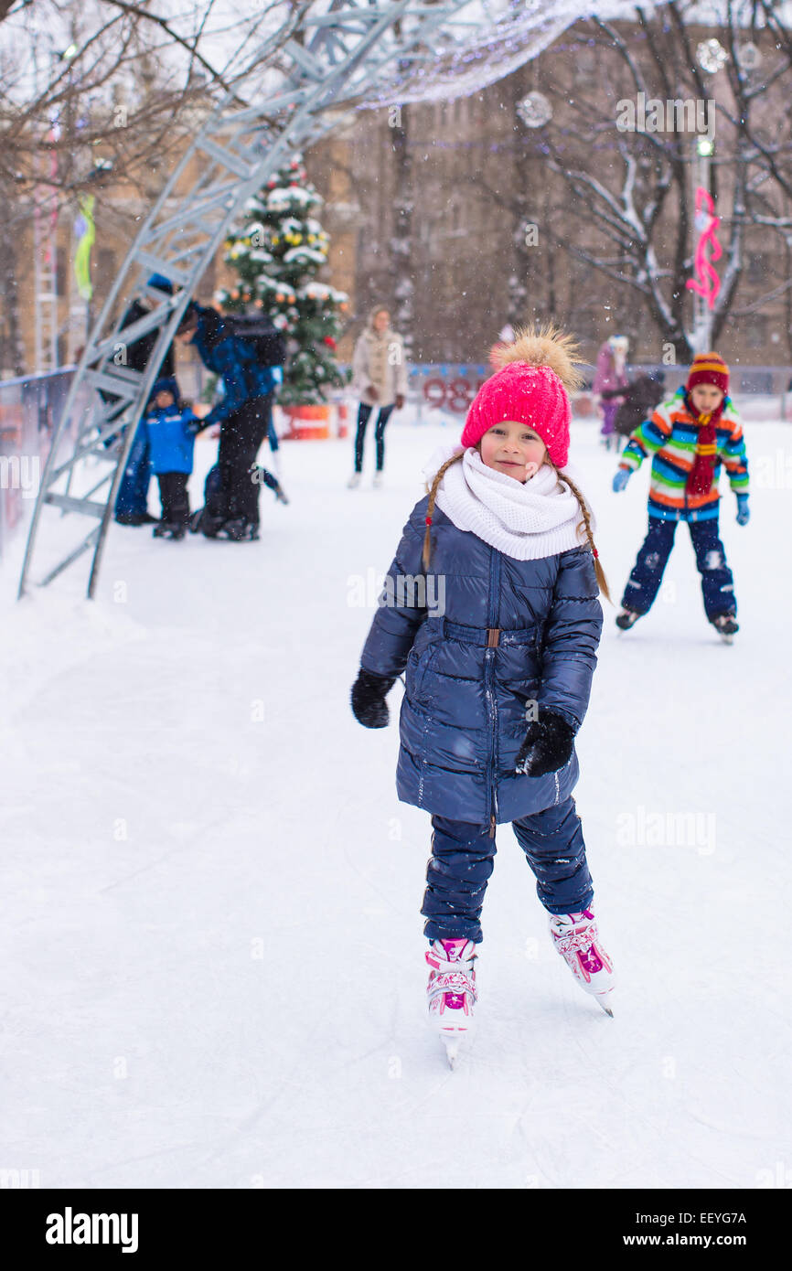 Adorable little girl skating on the icerink Stock Photo Alamy