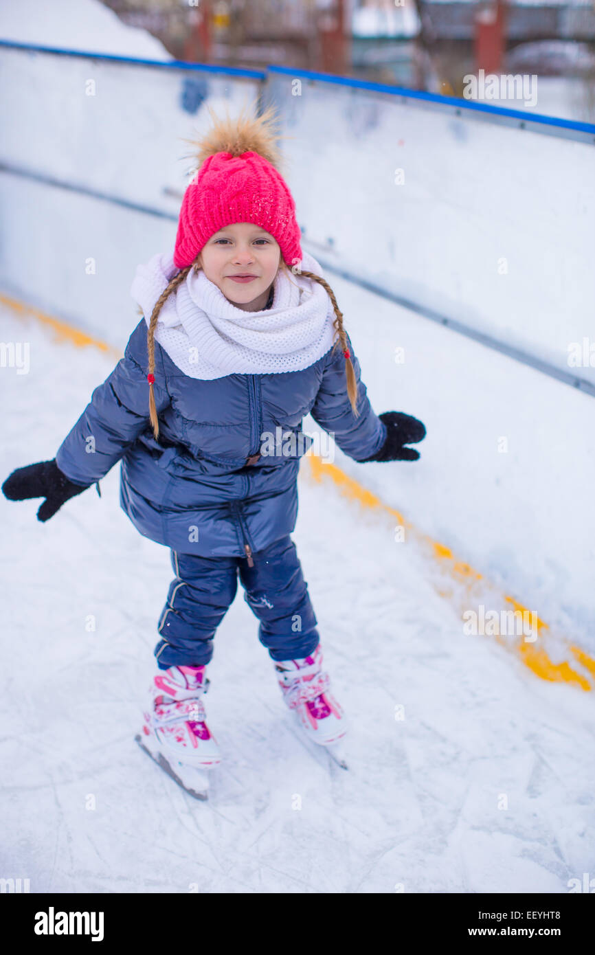 Adorable little girl skating on the icerink Stock Photo Alamy