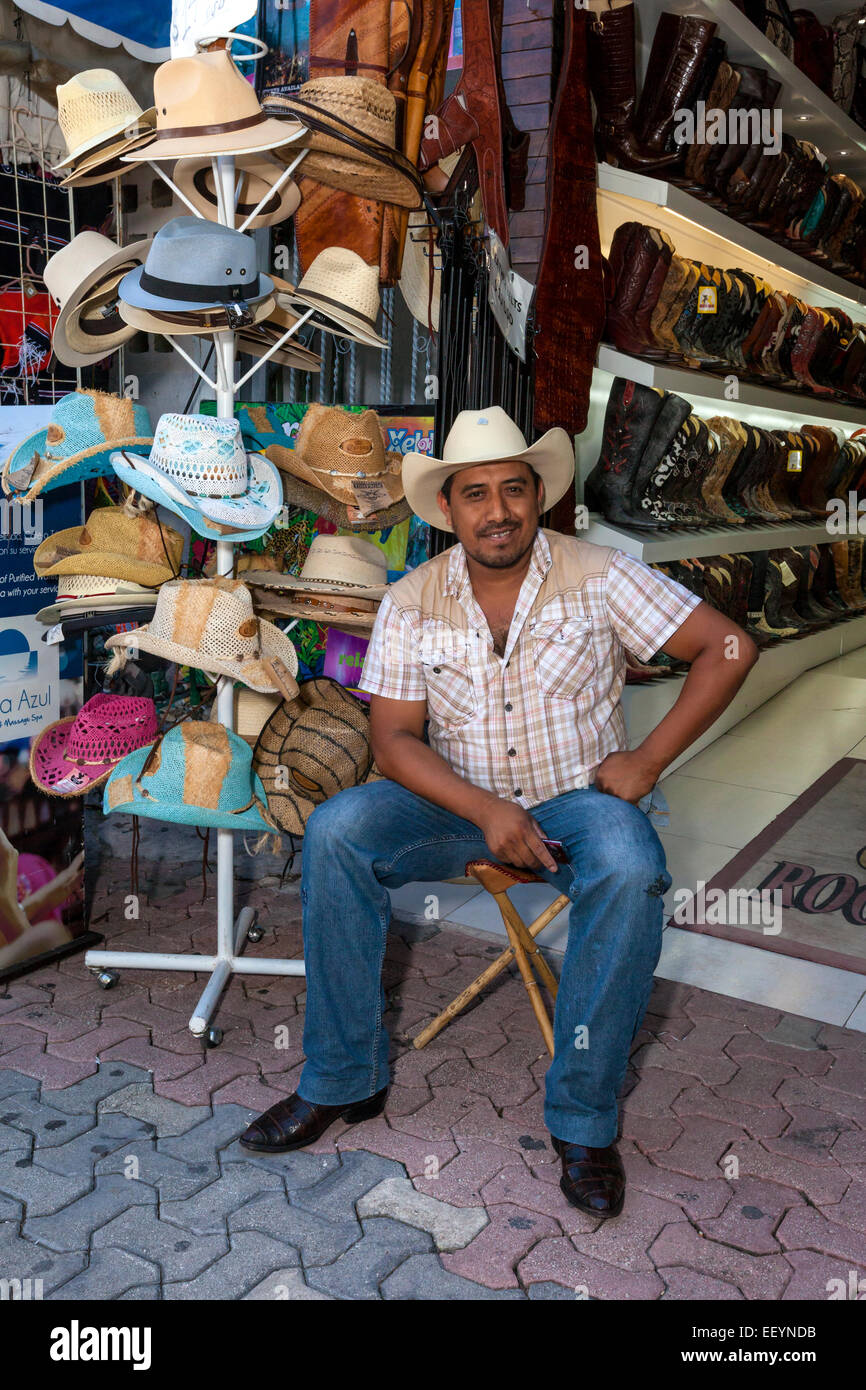 Store Clerk Selling Hats and Boots.  Playa del Carmen, Riviera Maya, Yucatan, Mexico. Stock Photo