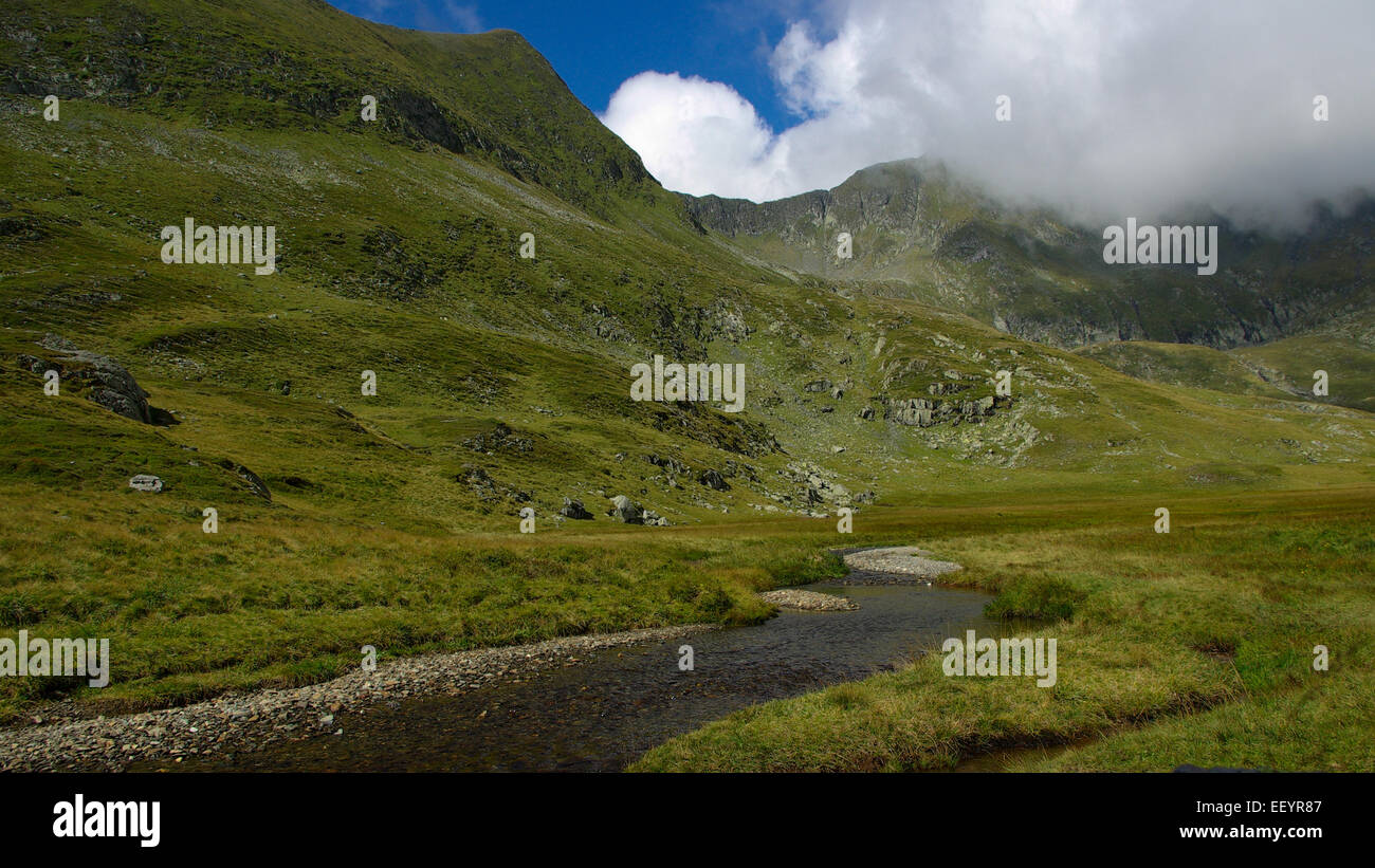 Mountain landscape with a river and clouds in the sky Stock Photo - Alamy