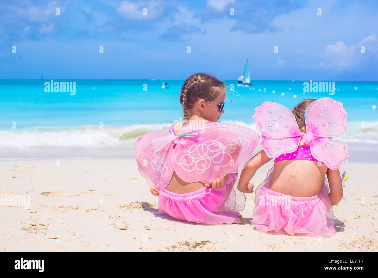 Little girls with butterfly wings on beach summer vacation Stock Photo