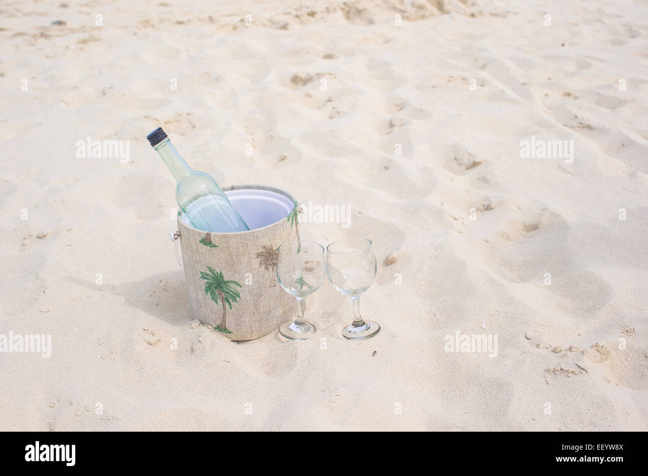 Bottle of wine and two glasses on sandy beach Stock Photo - Alamy