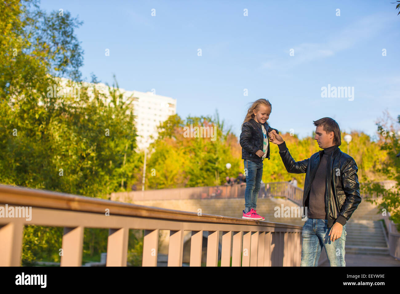 Father and cute daughter in autumn park outdoors Stock Photo - Alamy