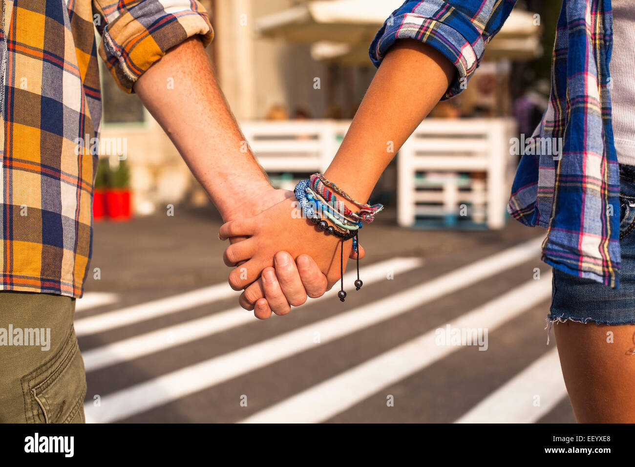 Young couple walking in the City holding hands, close-up. Stock Photo